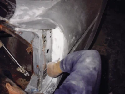 Technician working inside McBurnie Daytona Spyder body during restoration at Corvette Connection