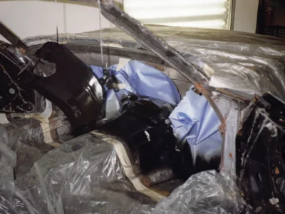 Technician working inside McBurnie Daytona Spyder body during fiberglass repair