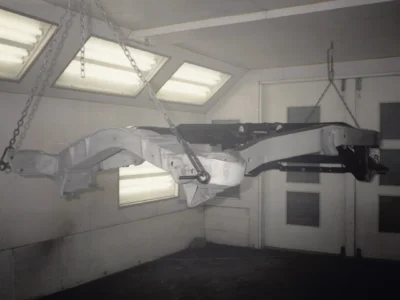 McBurnie Daytona Spyder C3 frame components in paint booth during restoration