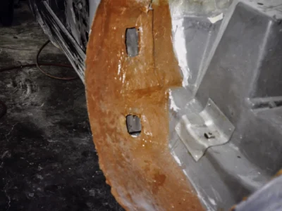 McBurnie Daytona Spyder body panel close-up showing fiberglass repair and primer areas