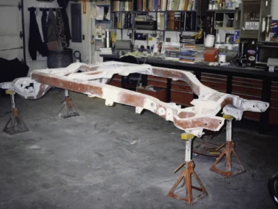 McBurnie Daytona Spyder C3 frame in red primer during frame restoration at Corvette Connection