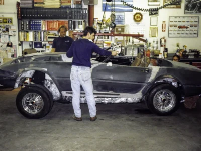 McBurnie Daytona Spyder in silver assembled with person standing next to car at Corvette Connection
