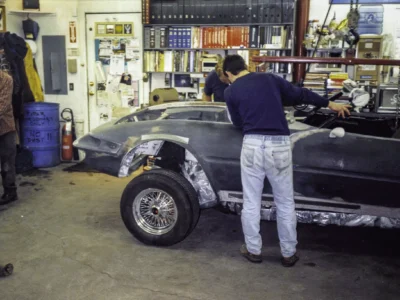 Technician inspecting McBurnie Daytona Spyder rear fender fitment at Corvette Connection