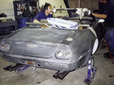 Technician fitting McBurnie Daytona Spyder front nose and headlight covers at Corvette Connection