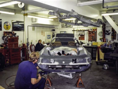 Technician working on McBurnie Daytona Spyder front end body fitting at Corvette Connection