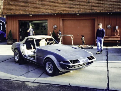 McBurnie Daytona Spyder in silver at Corvette Connection shop door in Bolton CT