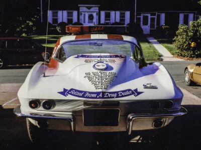 Remastered photo of a patriotic red, white, and blue 1970s Chevrolet Corvette pace car front view, showing custom graphics and restoration details by Corvette Connection.