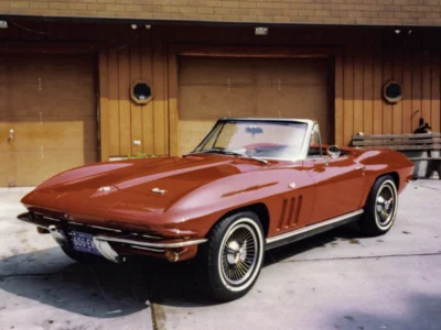 Remastered photo of a red 1965 Chevrolet Corvette convertible front angle restored by Corvette Connection in Bolton, Connecticut.