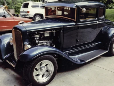 Remastered photo of a blue classic hot rod coupe front side angle photographed by Corvette Connection in Bolton, Connecticut.