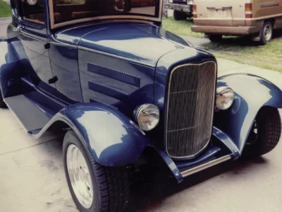 Remastered photo of a blue classic hot rod front grille and fender detail photographed by Corvette Connection in Bolton, Connecticut.