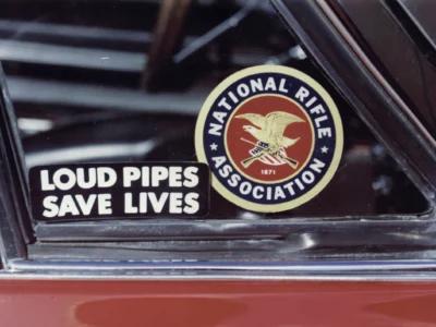 Remastered close-up photo of a National Rifle Association decal on a classic vehicle window at Corvette Connection in Bolton, Connecticut.