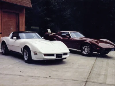 Remastered photo of a white 1984 Chevrolet Corvette coupe parked beside a red 1974 Chevrolet Corvette at Corvette Connection in Bolton, Connecticut.