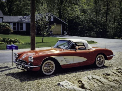 Remastered photo of a red and white 1959 Chevrolet Corvette convertible side view restored by Corvette Connection in Bolton, Connecticut.