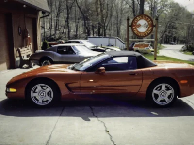 Remastered photo of a red 1990 Chevrolet Corvette coupe side profile photographed outside Corvette Connection in Bolton, Connecticut.