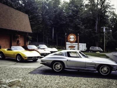 Remastered photo of several classic Chevrolet Corvettes parked outside Corvette Connection, including a silver mid-year Corvette coupe in the foreground and yellow and white Corvettes near the shop.