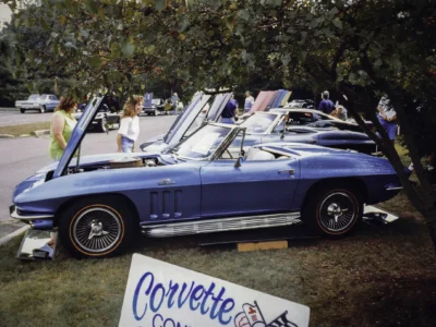 Remastered photo of a blue 1966 Chevrolet Corvette convertible displayed at a local car show with Corvette Connection signage in Bolton, Connecticut.