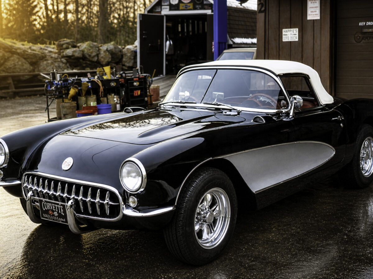 Enhanced original photo of a black and white 1957 Chevrolet Corvette convertible outside Corvette Connection in Bolton, Connecticut.