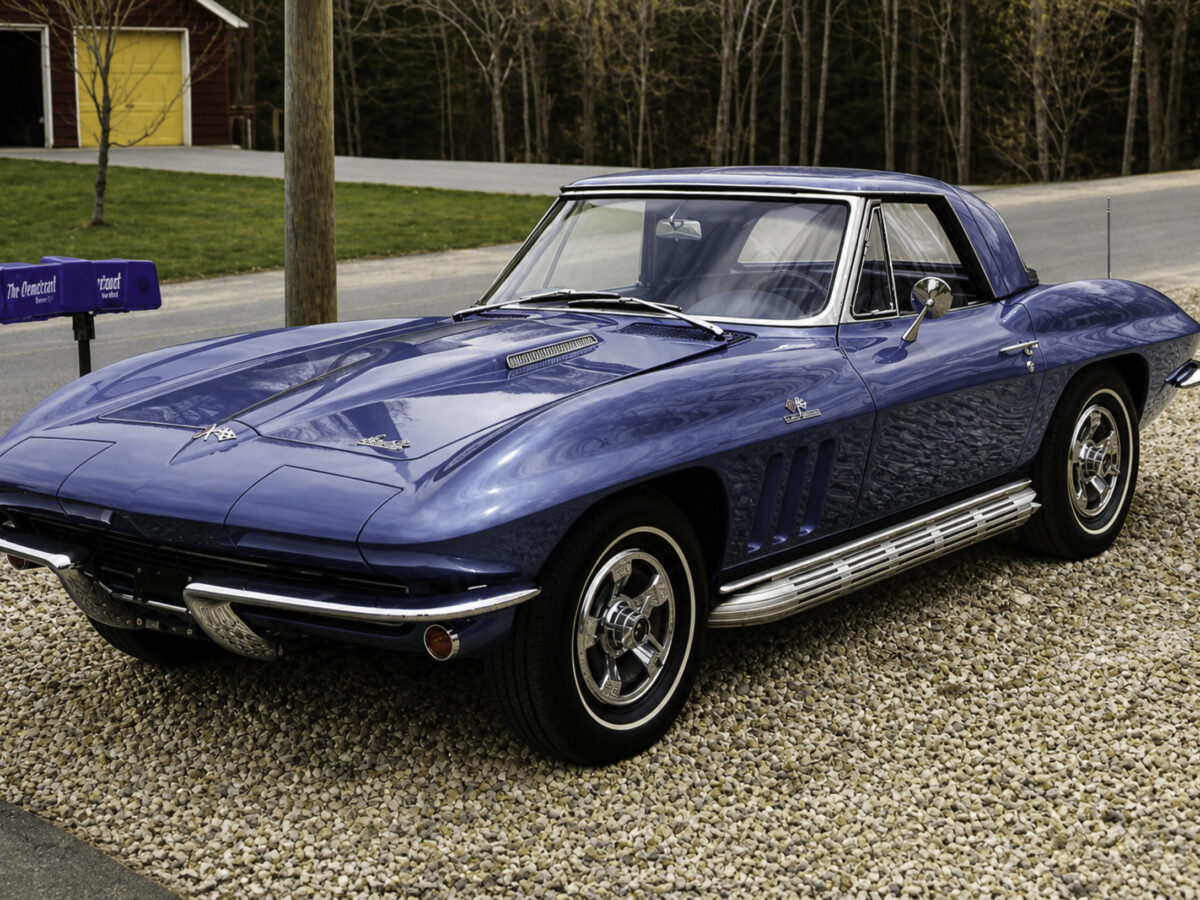 Enhanced original photo of a blue 1960s Chevrolet Corvette coupe photographed on a gravel driveway by Corvette Connection in Bolton, Connecticut.