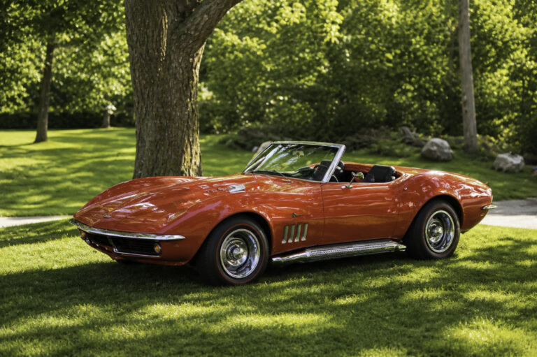 AI-remastered red classic Chevrolet Corvette convertible on a lawn after restoration by Corvette Connection in Bolton, Connecticut.